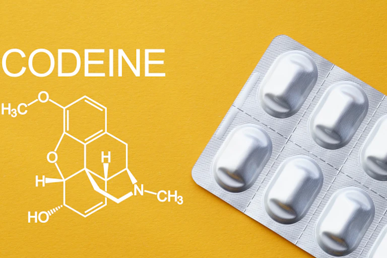 Silver pack of pills next to word 'CODEINE', which is written above the a chemical diagram.