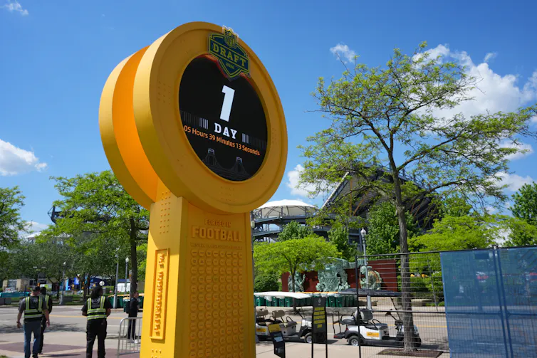 Closeup of a large, yellow countdown clock for the NFL Draft.