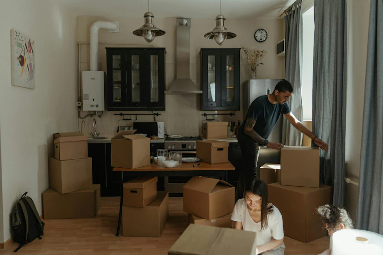 A family unpacking boxes in an apartment.