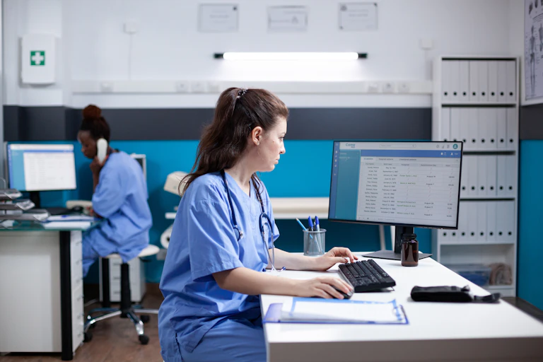A medic looking at a computer screen.