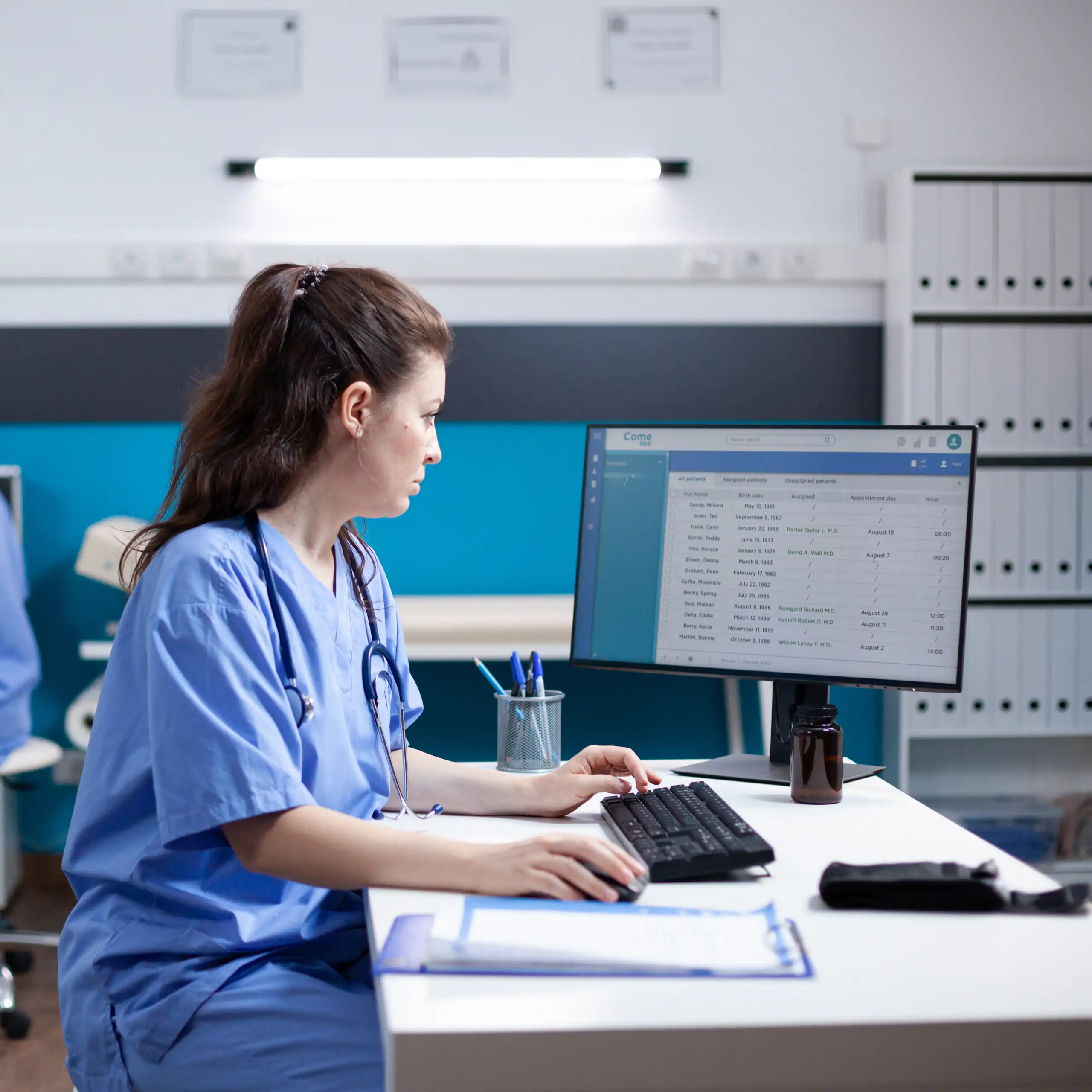 A medic looking at a computer screen.