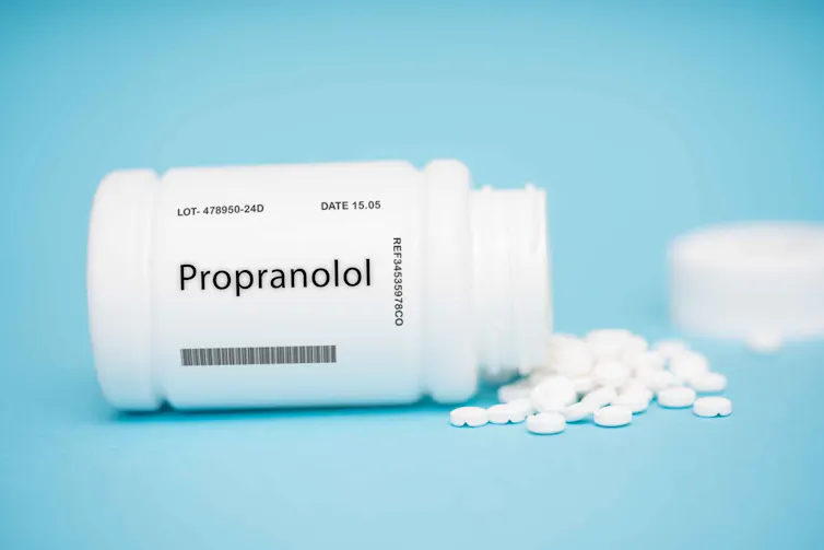 A bottle of propranolol, with pills spilling out.