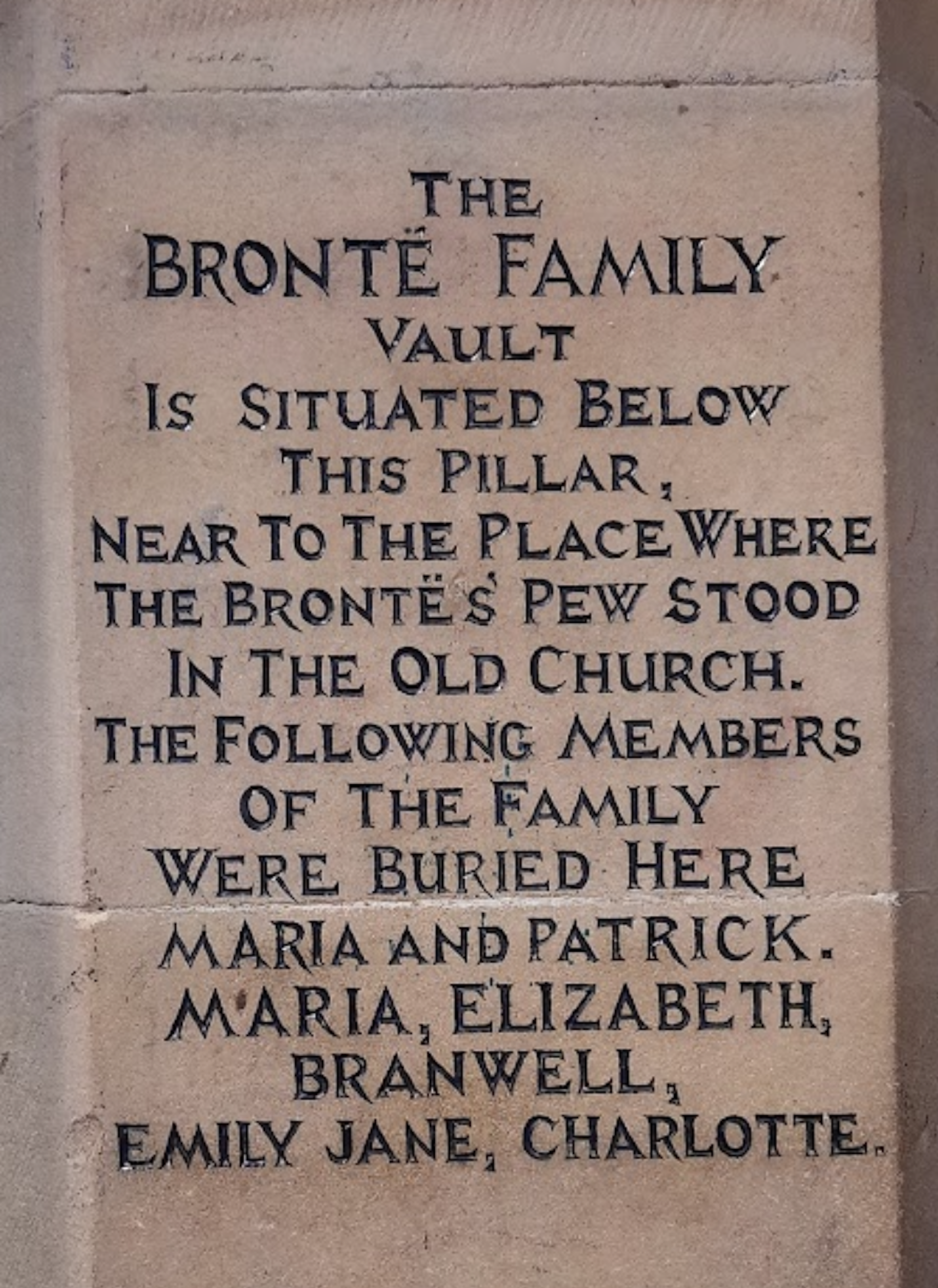 A tomb stone marking the graves of the Brontë children.