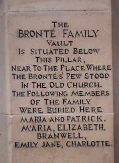 A tomb stone marking the graves of the Brontë children.