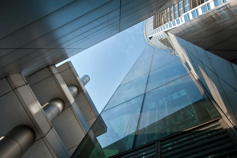 Upward shot of a tall, glass-fronted buildings