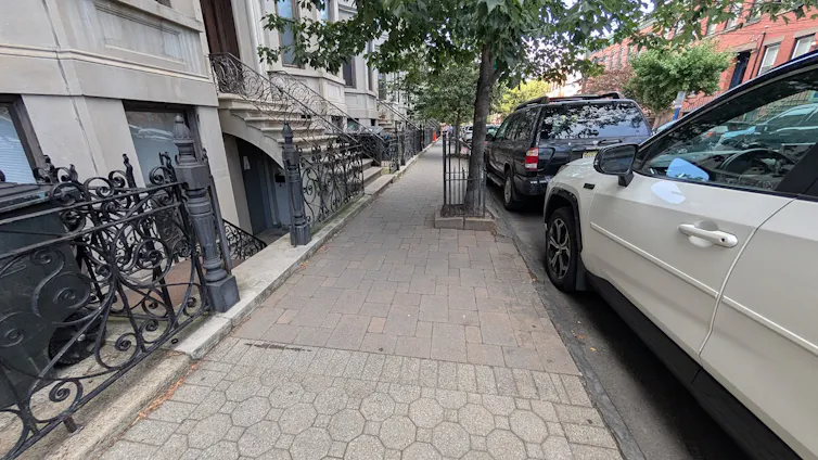 A brick sidewalk that is smooth and walkable.