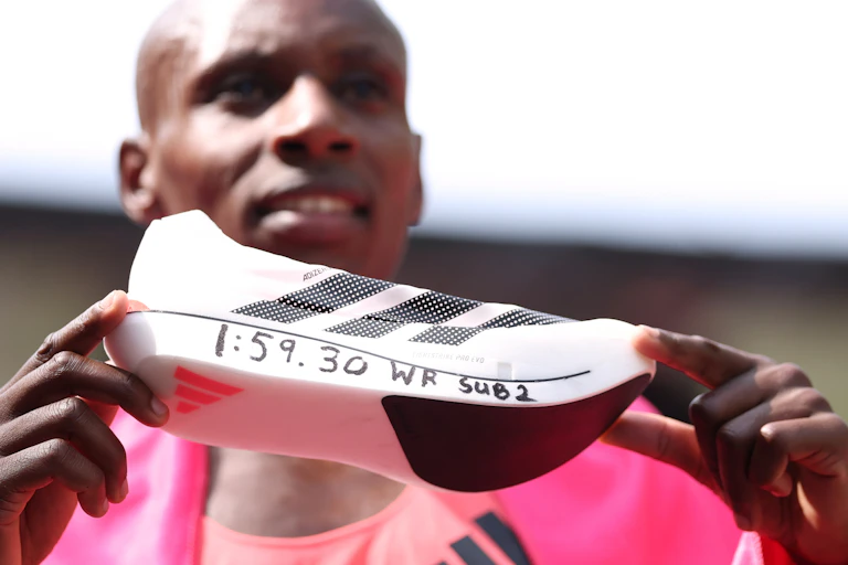 Sebastian Sawe from Kenya shows off his supershoe after winning the men's race at the London Marathon.