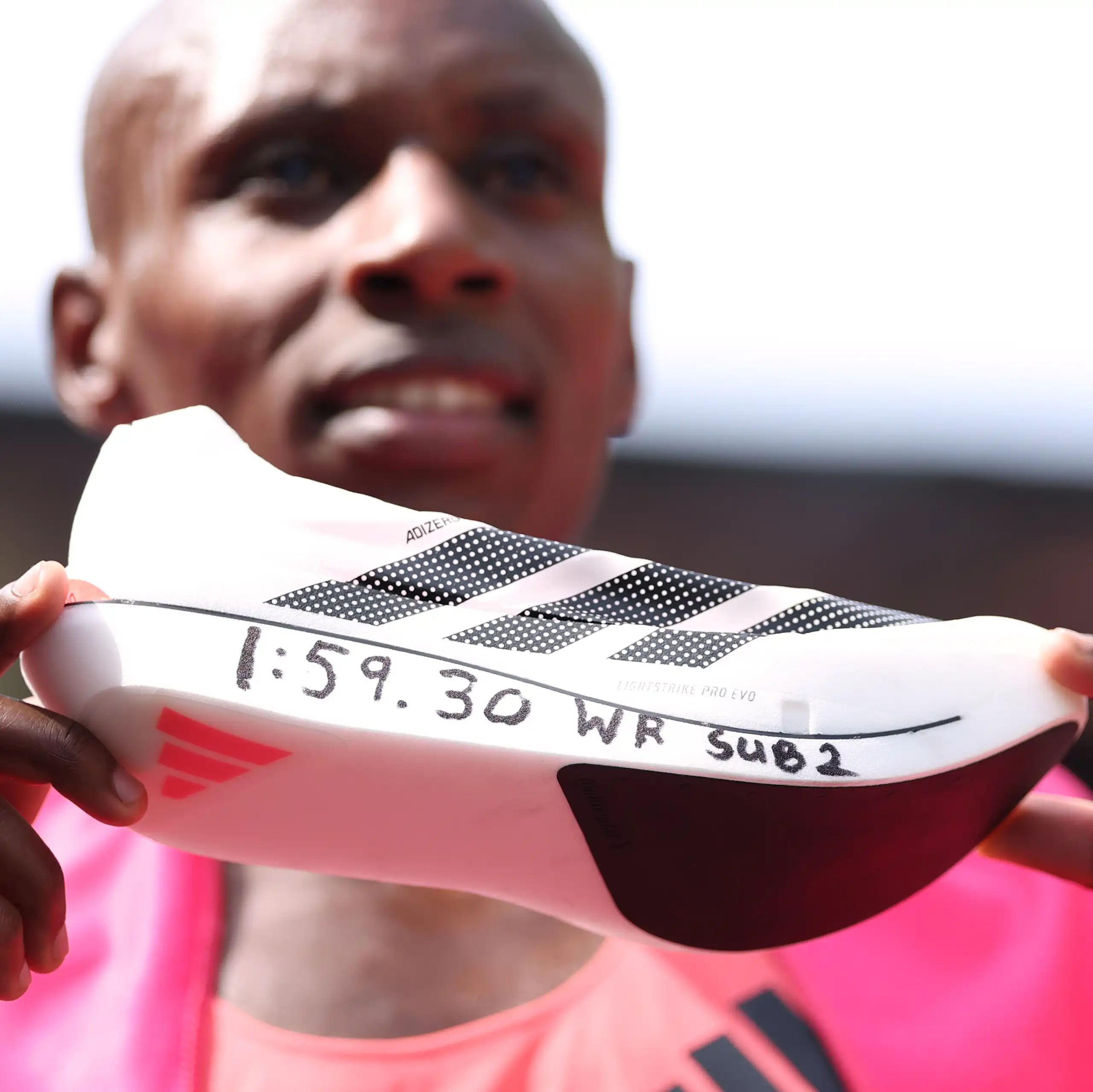 Sebastian Sawe from Kenya shows off his supershoe after winning the men's race at the London Marathon.