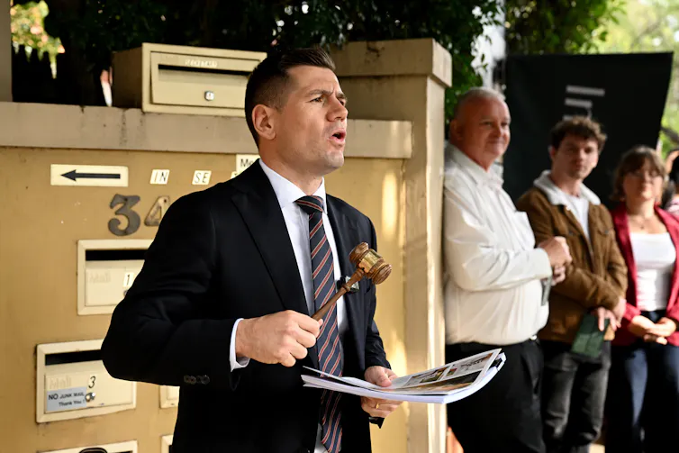 An auctioneer leads an auction at a property in Sydney