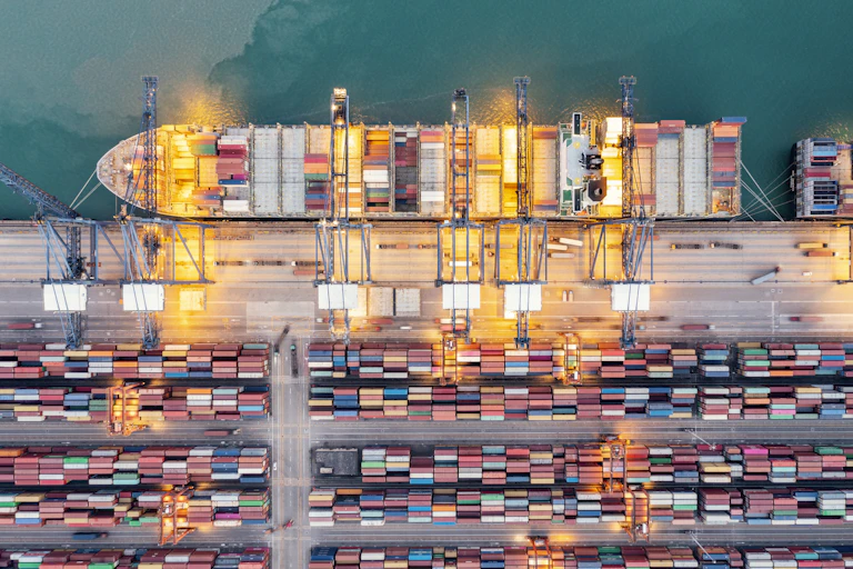 aerial view of a container ship being loaded at port.