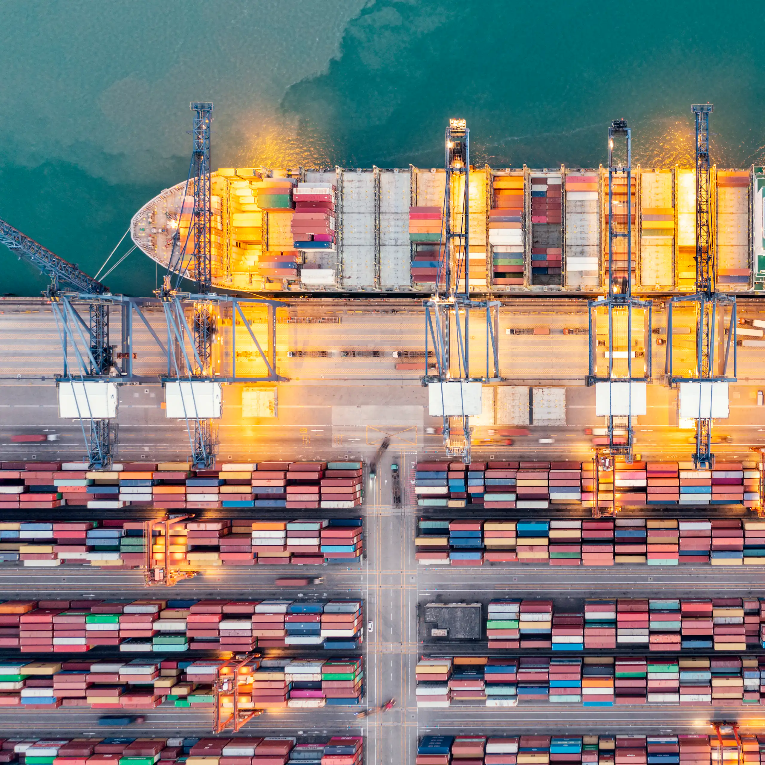 aerial view of a container ship being loaded at port.