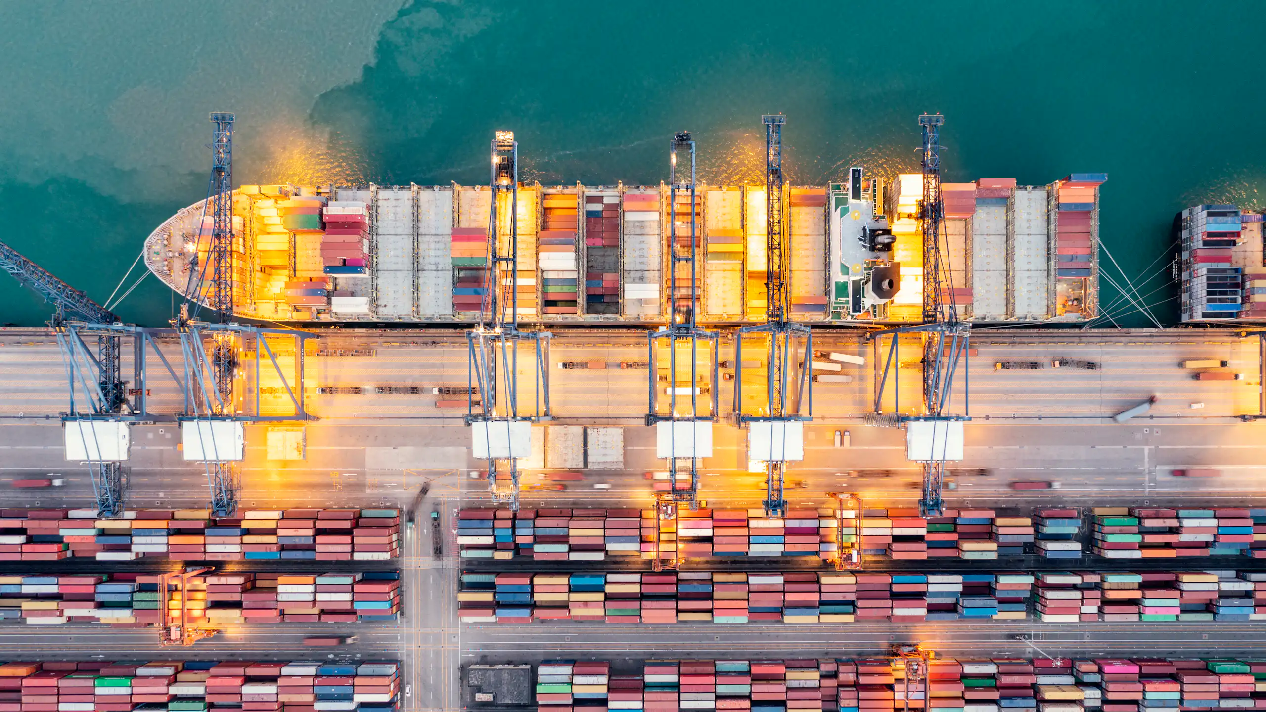 aerial view of a container ship being loaded at port.