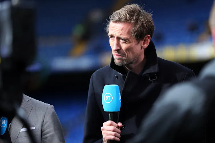 Peter Crouch holding a microphone