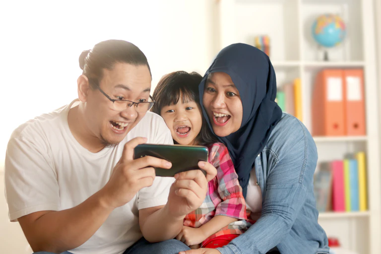 Parents and child looking at smartphone