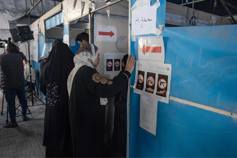 A Palestinian woman prepares to enter a polling booth, April 25 2026.