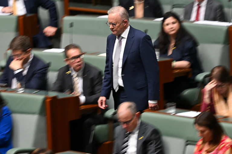 Australian Prime Minister Anthony Albanese walks through the House of Representatives.