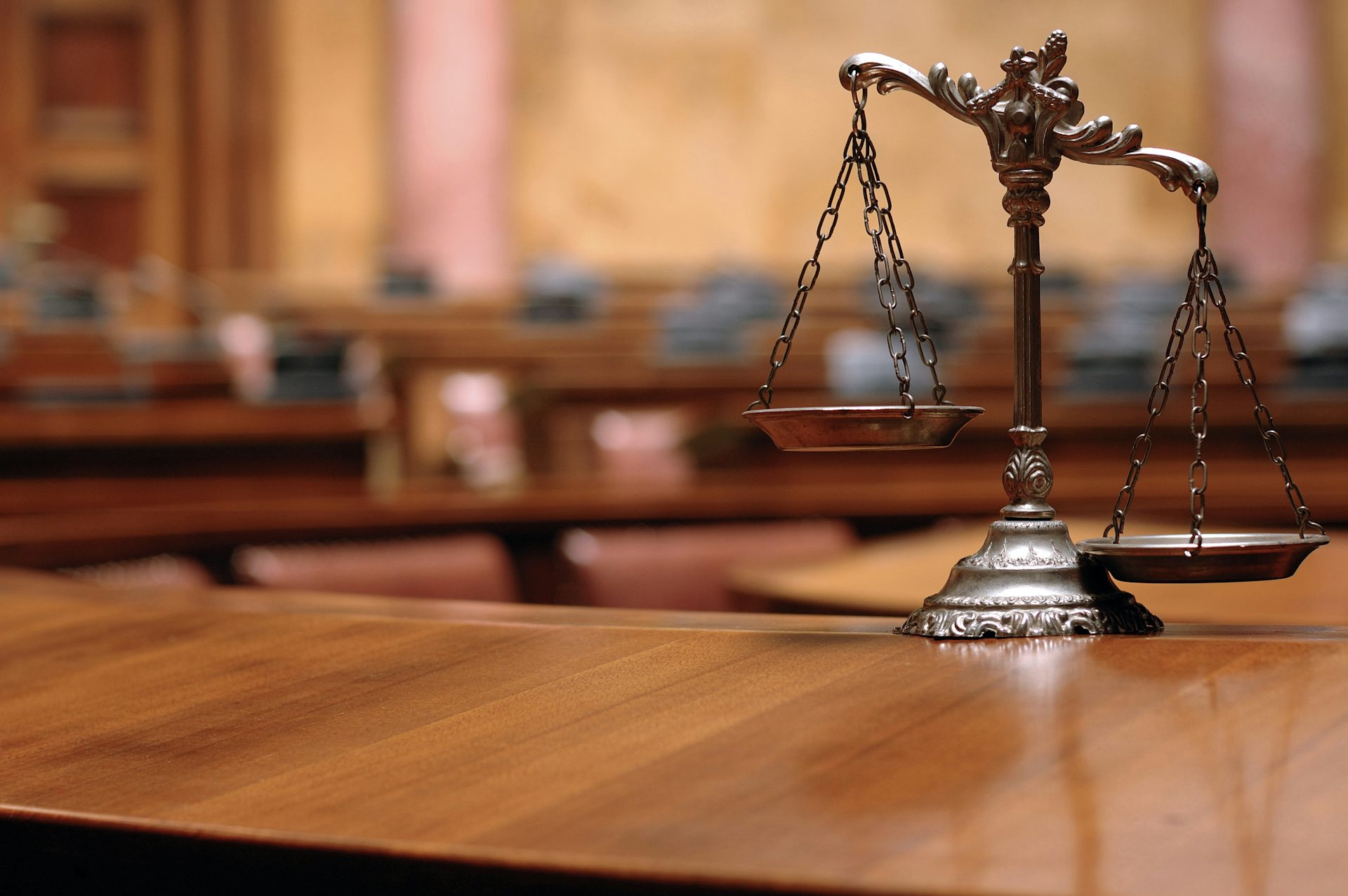 A pair of scales on a courtroom desk.