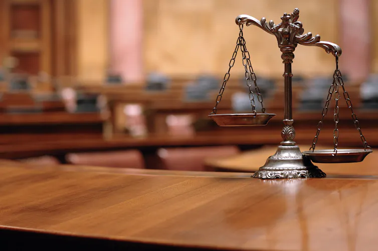 A pair of scales on a courtroom desk.