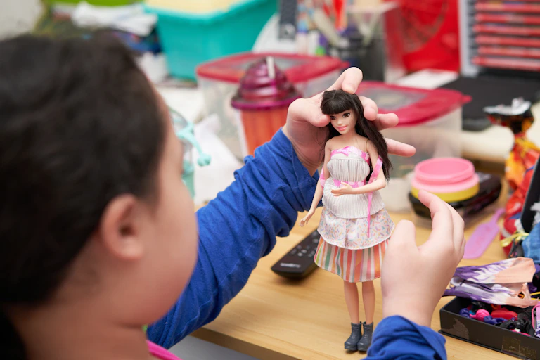 Child playing with a doll.