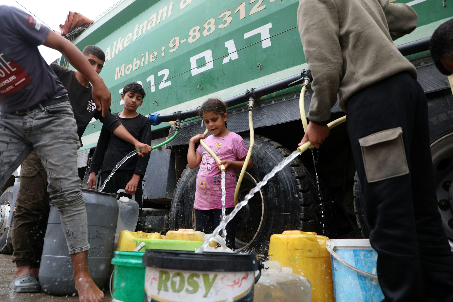 Water being distributed from an aid truck.
