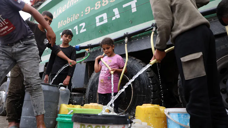Water being distributed from an aid truck.