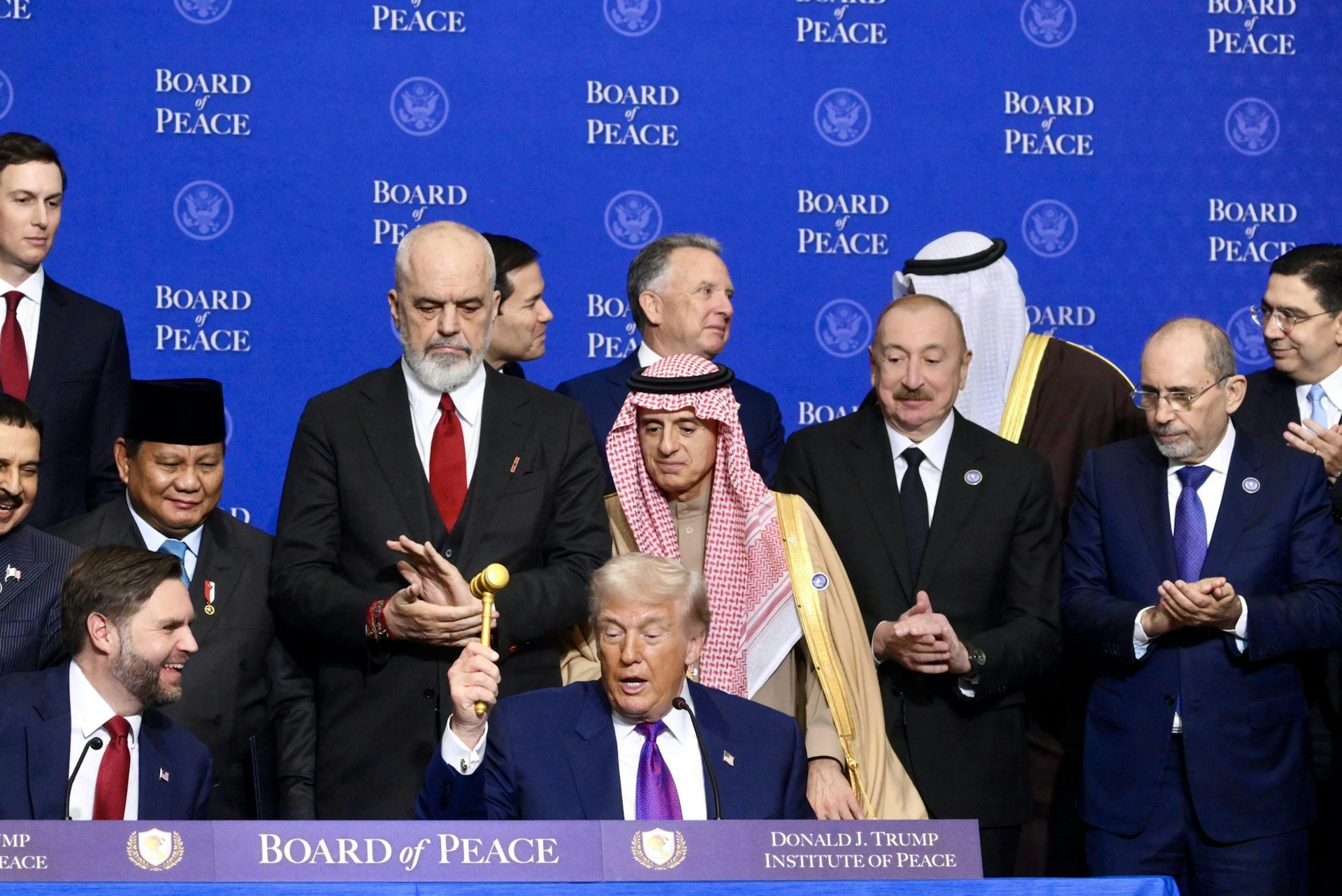 Donald Trump sits surrounded by members of his Board of Peace, Washington February 19 2026.