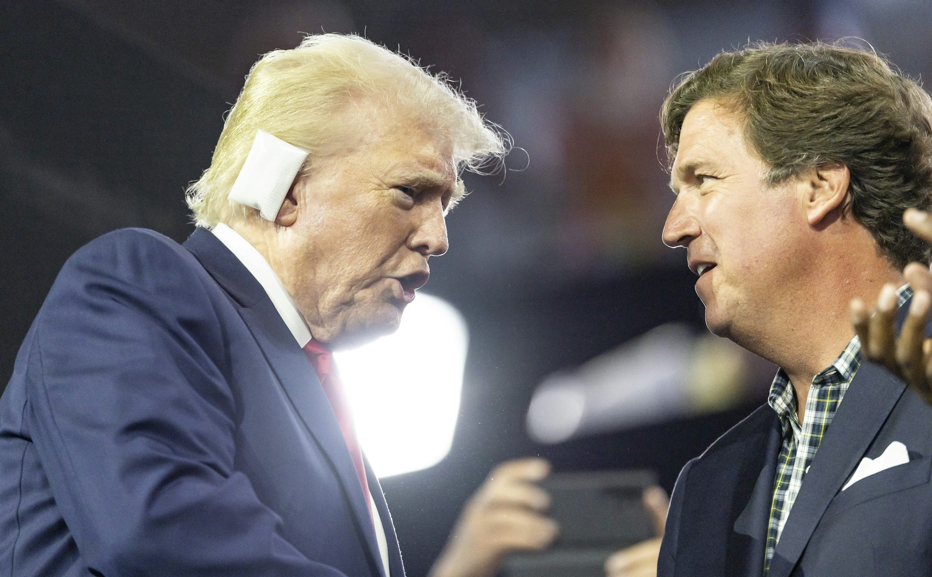 Trump speaks with Carlson at the Republican National Convention.
