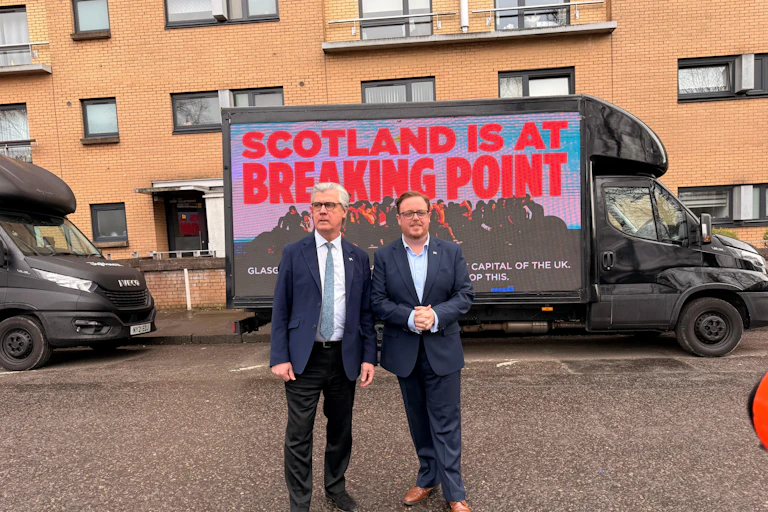 Reform UK Scotland leader Malcolm Offord, Holyrood candidate Thomas Kerr, and billboard