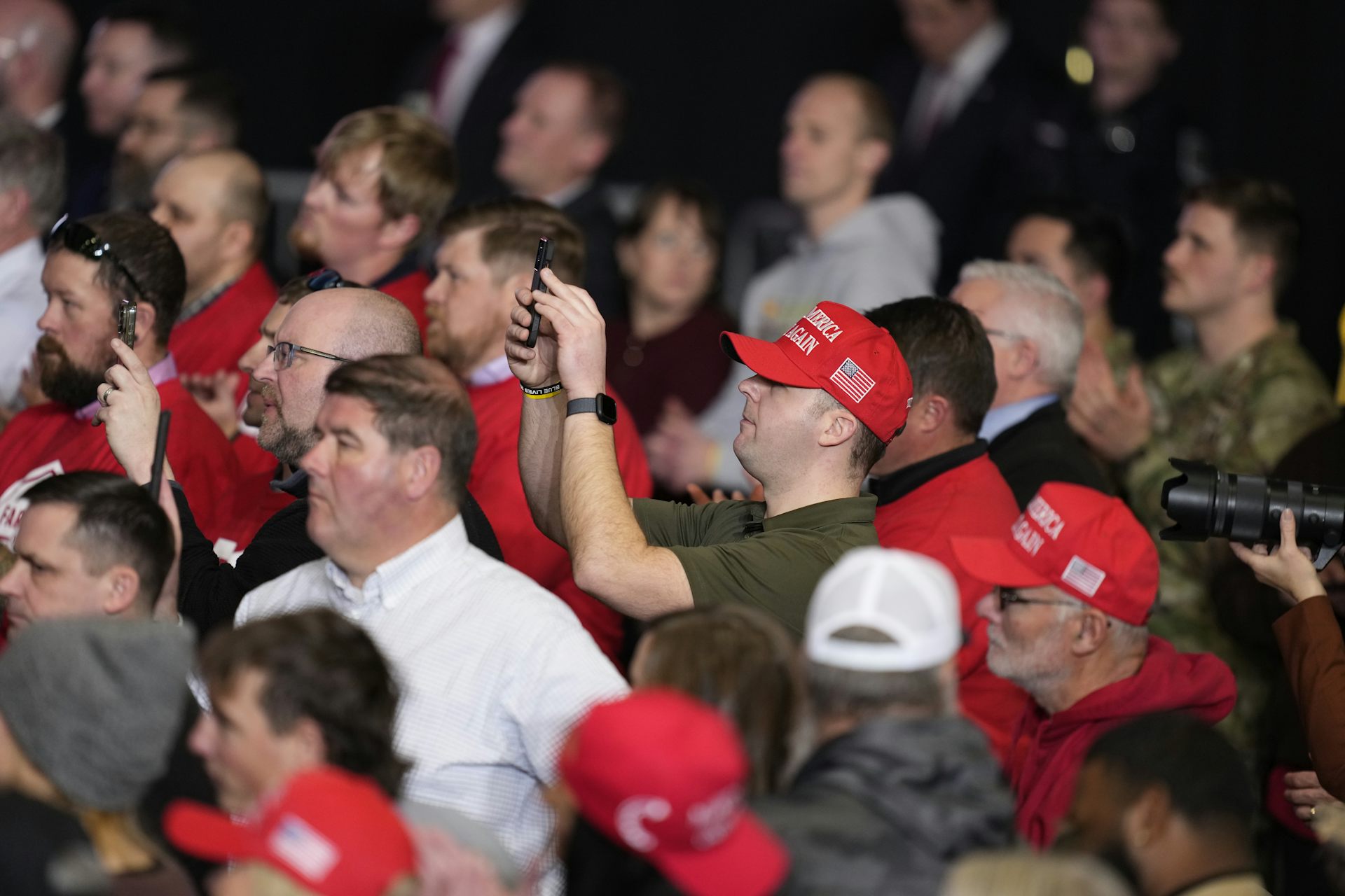 Maga supporters watch as Trump delivers remarks on the economy.