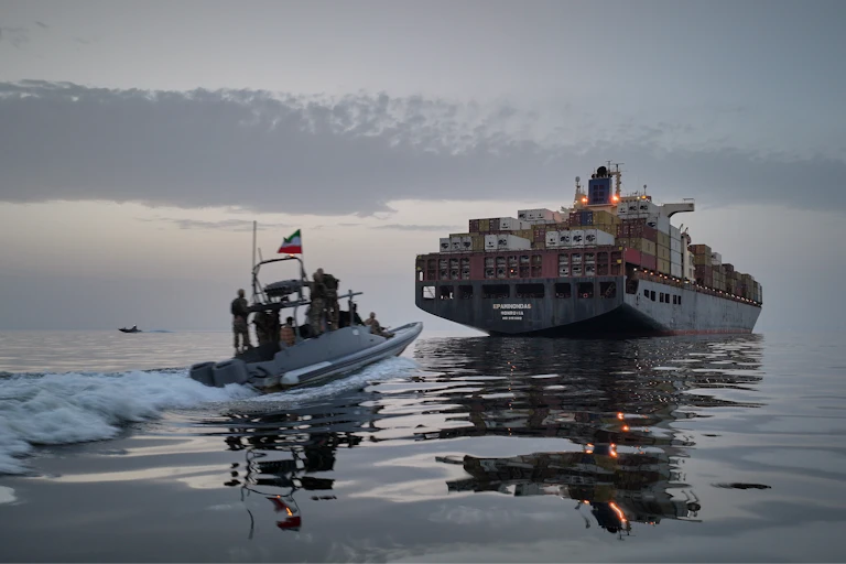 In this photo released by Tasnim News Agency, a Revolutionary Guard Navy (IRGC) speedboat approaches the cargo ship Epaminondas during what state media described as the seizure of one of two vessels accused of violations in the Strait of Hormuz