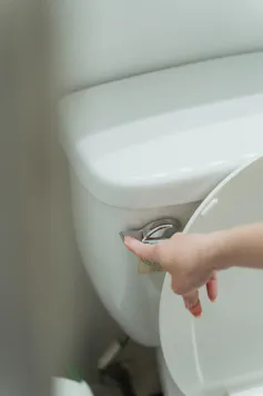 Person flushes a toilet