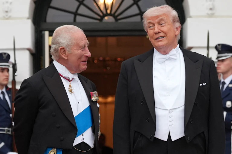 Two old men in white tie laugh together