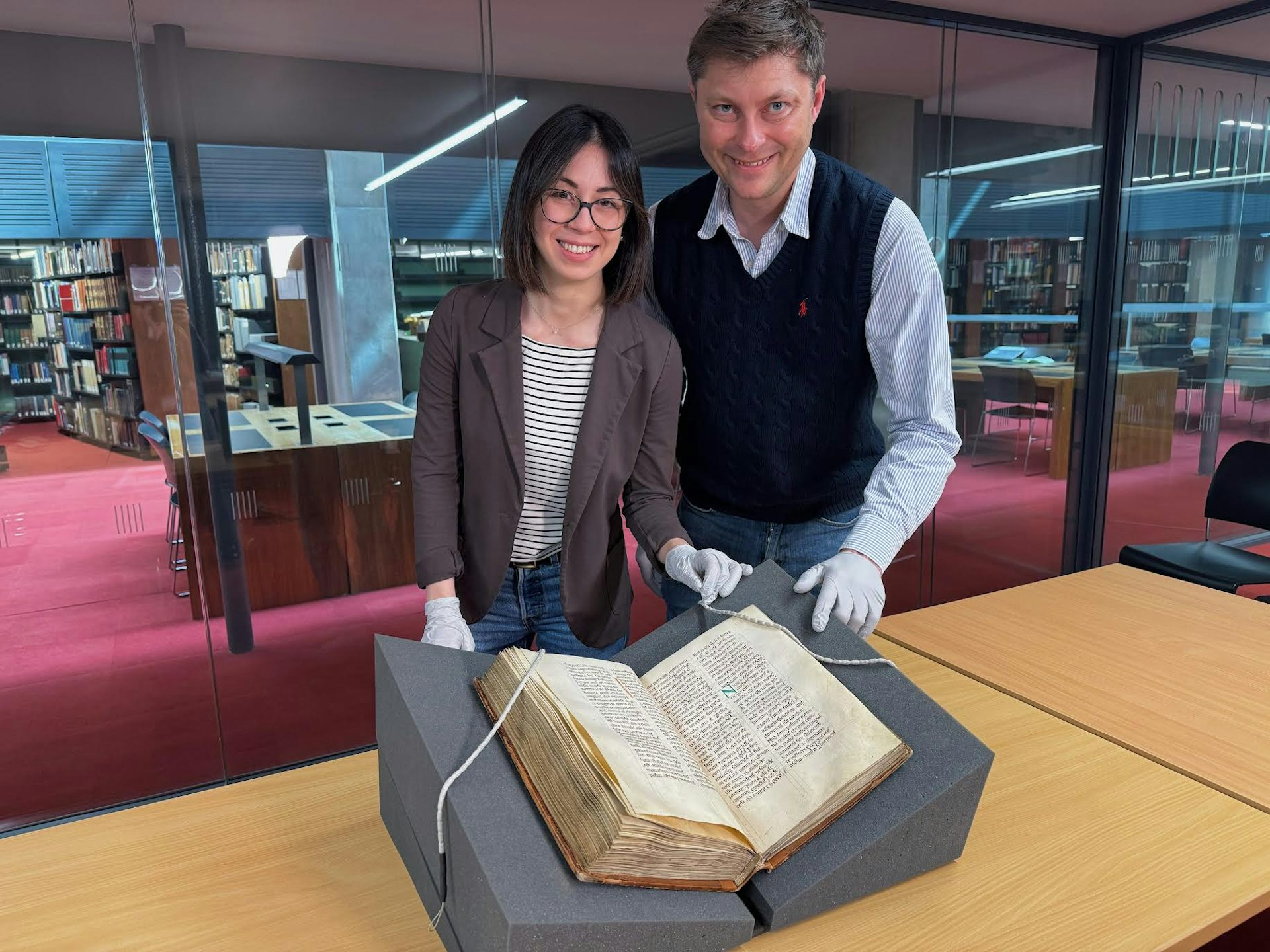 Elisabetta Magnanti and Mark Faulkner with a copy of Bede&rsquo;s Ecclesiastical History of the English People.