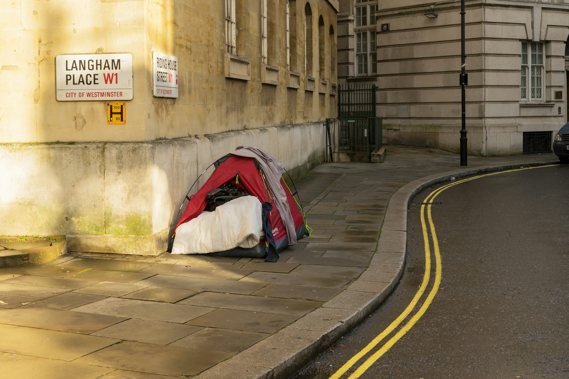 Homeless person's tent on the corner of a street in London.