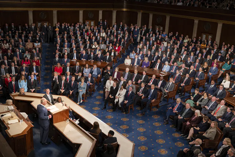 Wide view of US representatives seated in the House chamber during the king's address