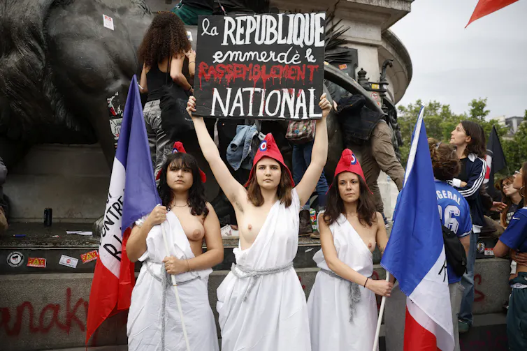 Marijana: why did the Republic make a choice a disembodied girl as an emblem of nationwide harmony? 1 Demonstrators dressed in traditional Marian costumes take part in an anti-far-right rally at Place de la Republique in Paris, July 3, 2024, ahead of the second round of French parliamentary elections.