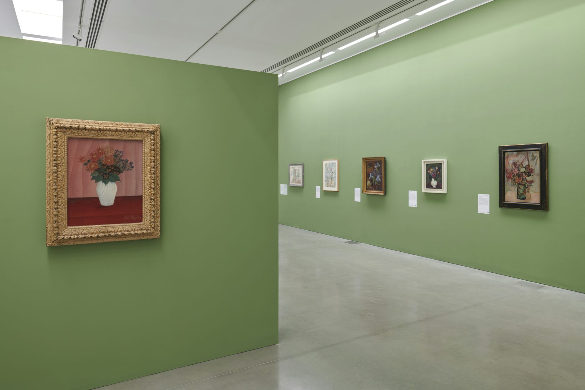 Rousseau’s Bouquet of Flowers inside the exhibition, with green walls