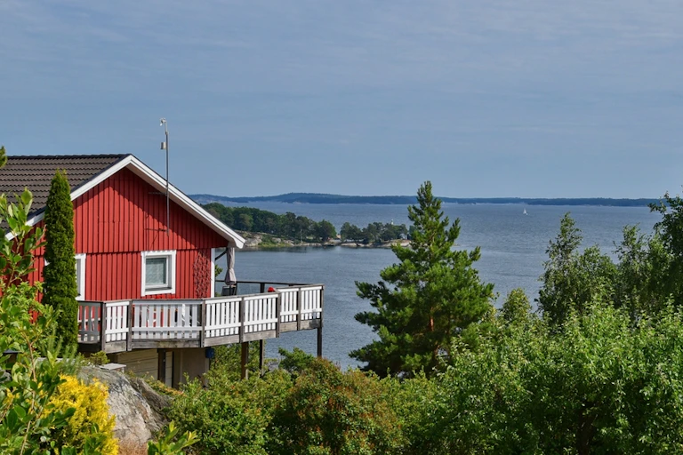 A Swedish cabin beside a lake.