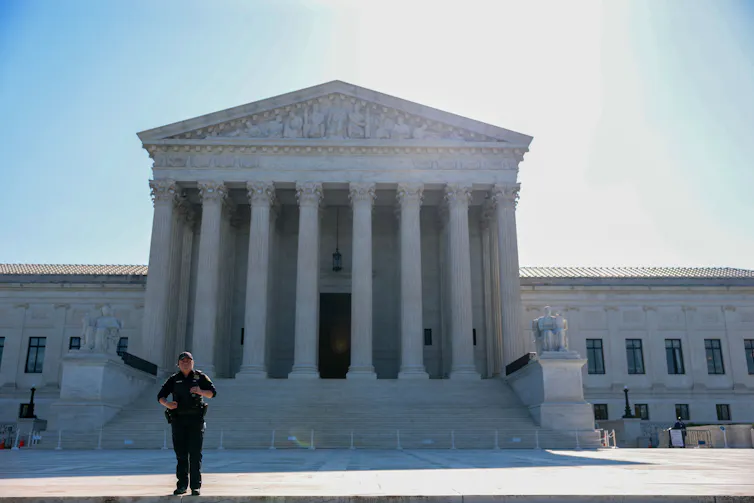 A large white building with pillars on the front of the portico.