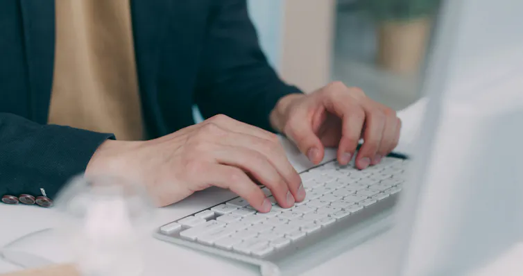 Person typing on a laptop keyboard