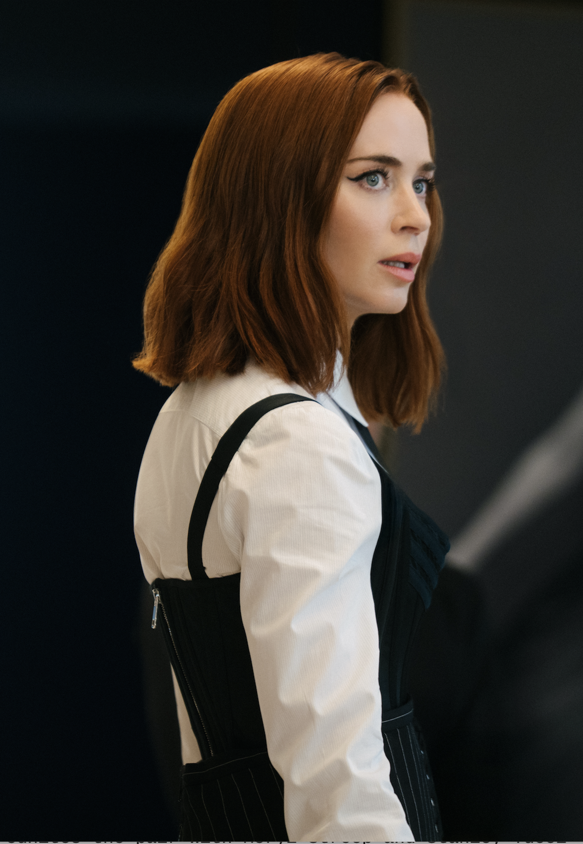 A young woman with red hair looking incredulous.