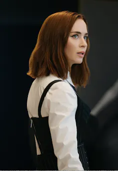 A young woman with red hair looking incredulous.