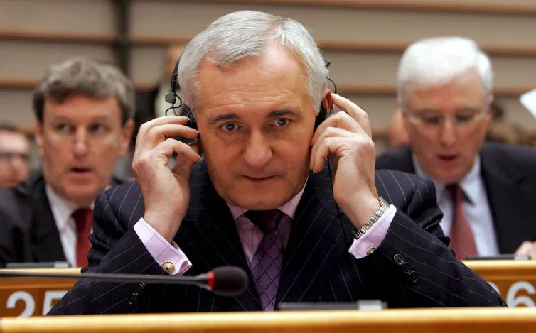 Bertie Ahern listening on headphones