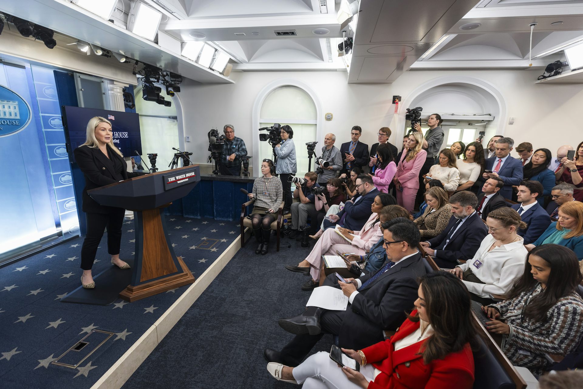 White House press secretary addresses the press in the Press Briefing Room.