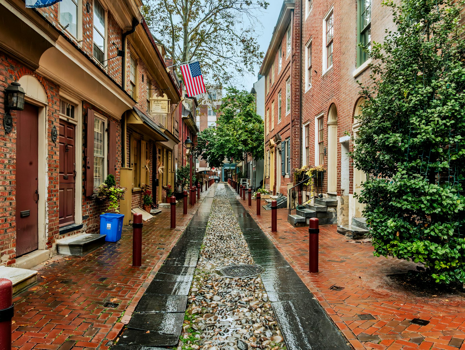 Rows of two-story, red-brick homes on cobblestone street
