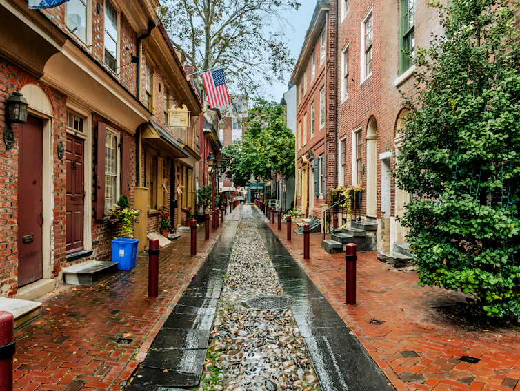 Rows of two-story, red-brick homes on cobblestone street