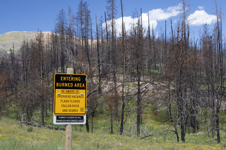 A sign says readers are entering a burned area with hazards.