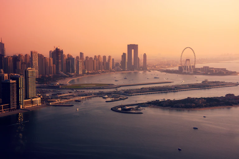The Dubai skyline at sunset.