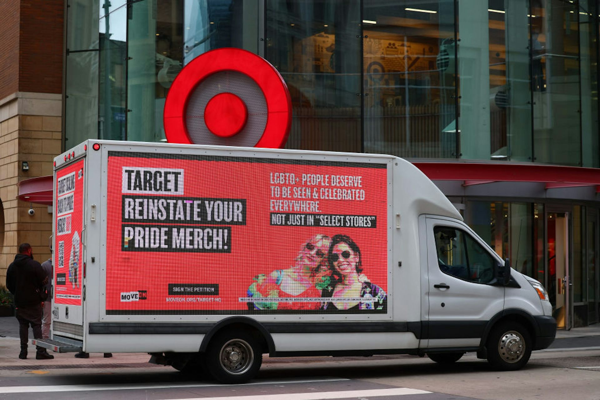 A large truck covered with a billboard that reads 