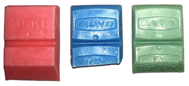 Three wax bars in different colors.